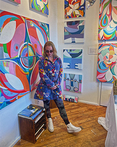 Emily posing surrounded by modern art.