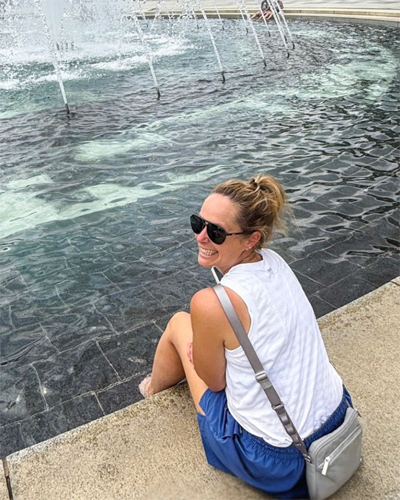 Mackenzie in front of a fountain.